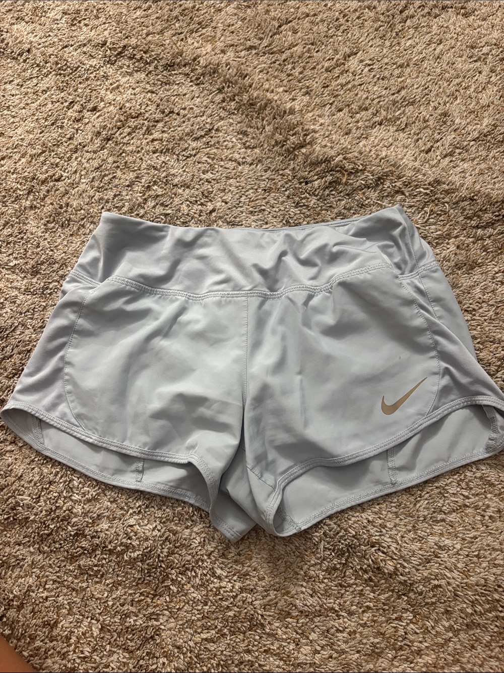 Nike Women's Light Gray Athletic Shorts with Gold Swoosh